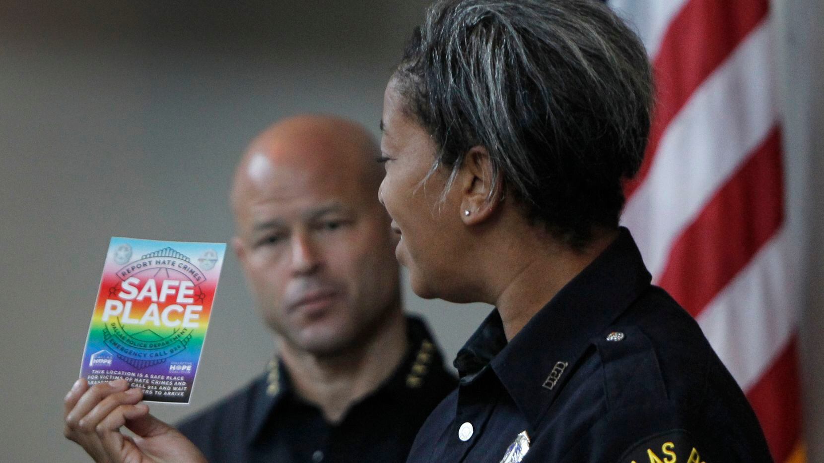 Dallas Police Department's new LGBTQ+ liaison, officer Megan Thomas displays the Safe Place business designations for potential targets of hate crimes until police can arrive in times of immediacy. Police Chief Eddie Garcia looks on in the background. The launch of the Safe Place Program was held at the Dallas police Department headquarters at 1400 Botham Jean Blvd. in Dallas on June 28, 2021. (Steve Hamm/ Special Contributor)