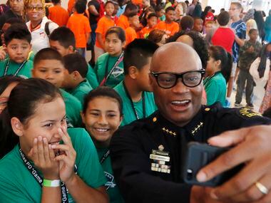 Dallas Chief of Police David Brown takes a selfie with a group of kids during "Let's Talk,"...