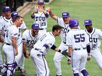 TCU players celebrate with Brayden Taylor (55) after his first inning home run during their...