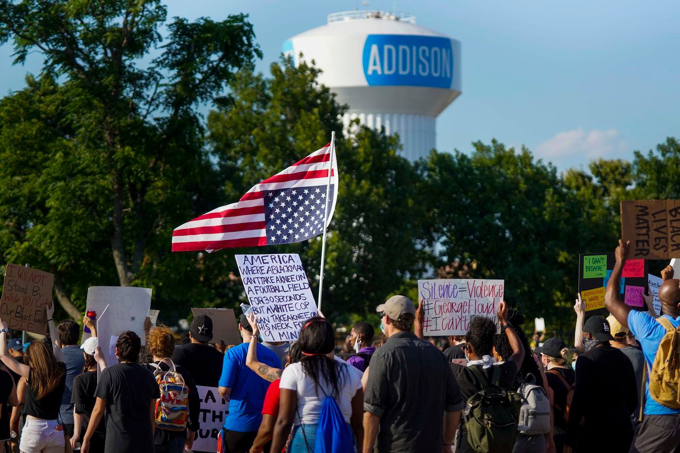 Demonstrators march on the Addison Road toward Addison Circle Park during a protest on...