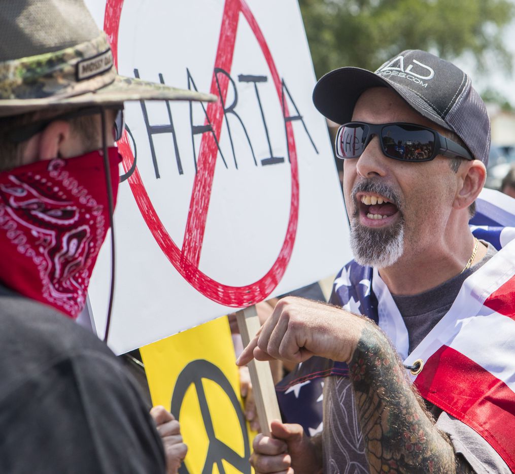 An anti-Shariah protester, who refused to provide his name, verbally clashes with an counter protesters Saturday, June 10, 2017, at the intersection of Abrams Road and Centennial Boulevard in Richardson, Texas. 