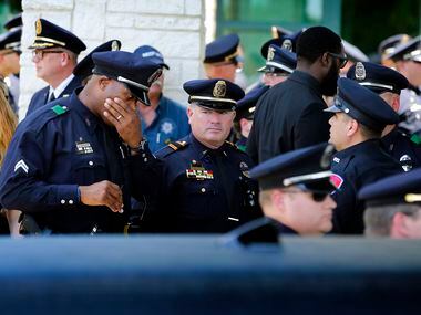 Police officers broke salute and mingled a bit before the hearse and the funeral procession...