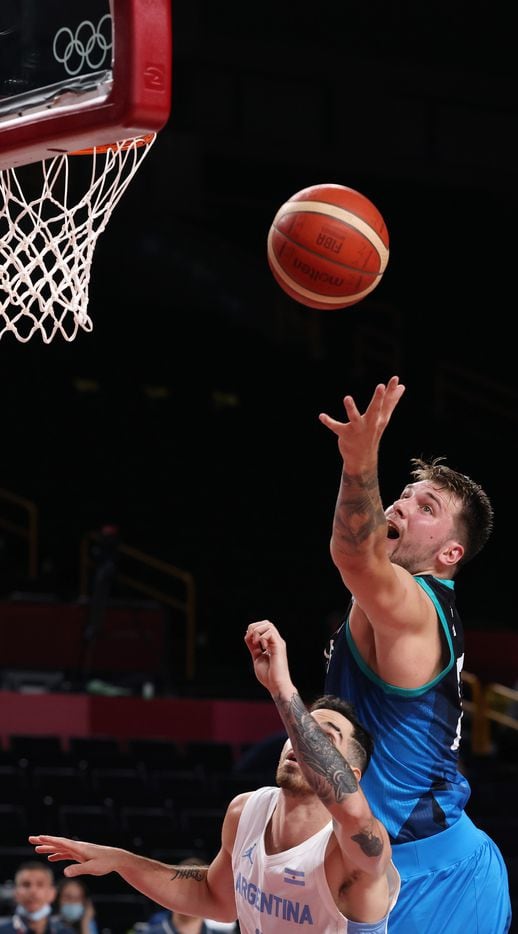 Slovenia’s Luka Doncic (77) and Argentina’s Luca Vildoza (17) go after the ball for a rebound in the first half of play during the postponed 2020 Tokyo Olympics at Saitama Super Arena on Monday, July 26, 2021, in Saitama, Japan. Slovenia defeated Argentina 118-100. (Vernon Bryant/The Dallas Morning News)