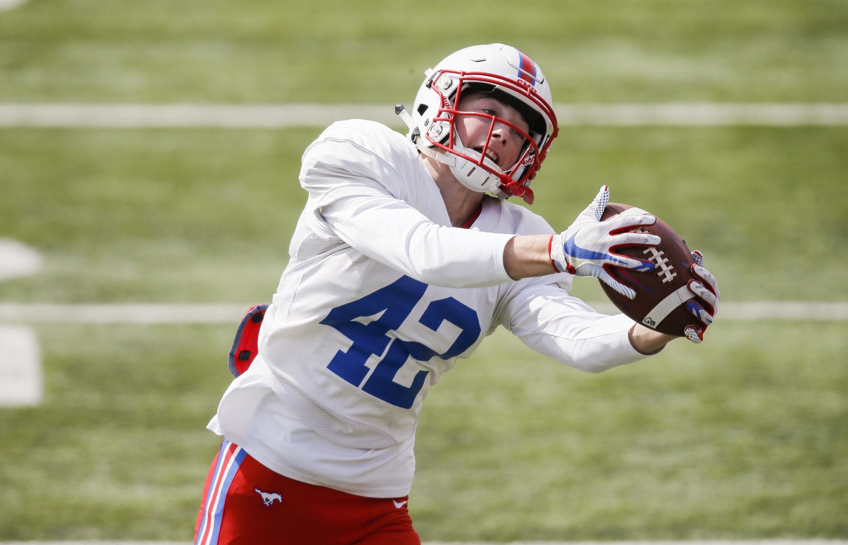 SMU wide receiver Beau Barker (42) catches a pass during practice at Gerald Ford Stadium,...