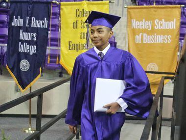 14-year-old Carson Huey-You walks off the stage after receiving a bachelor's degree in...