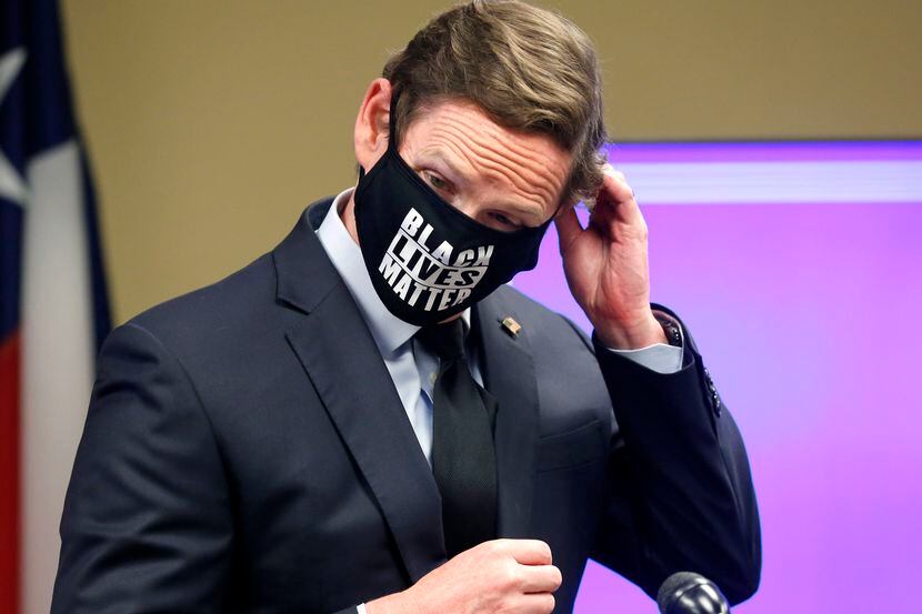 Dallas County Judge Clay Jenkins removes his Black Lives Matters mask to answer a question...