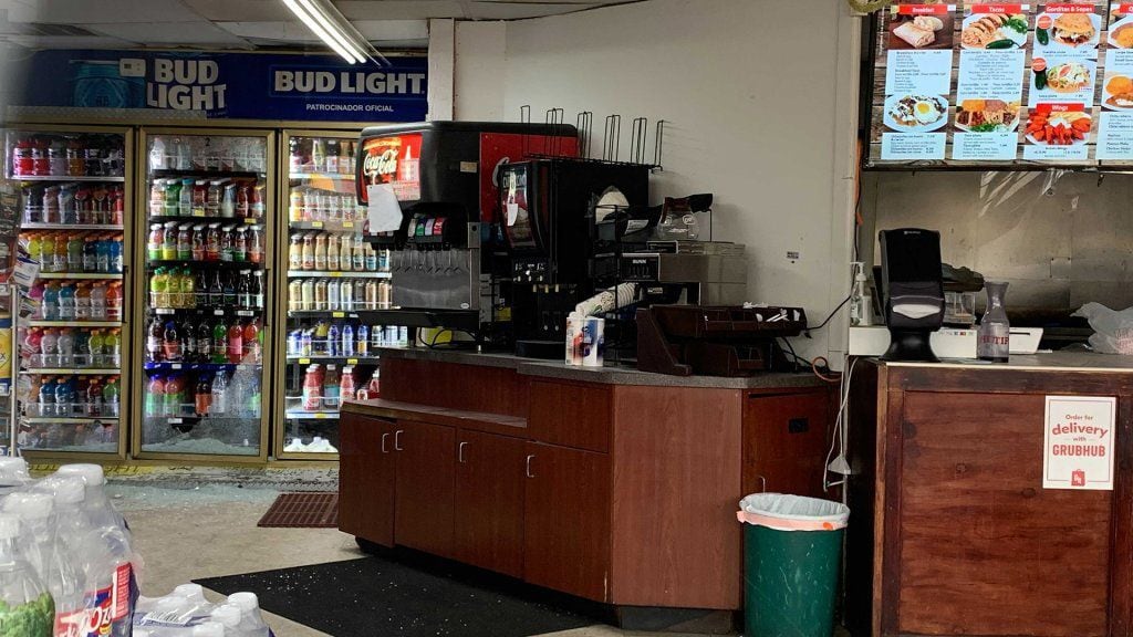 The scene on Monday, Dec. 27, 2021, at the Garland gas station where a gunman fatally shot three people and critically injured another the night before. Broken glass can be seen toward the back of the store.