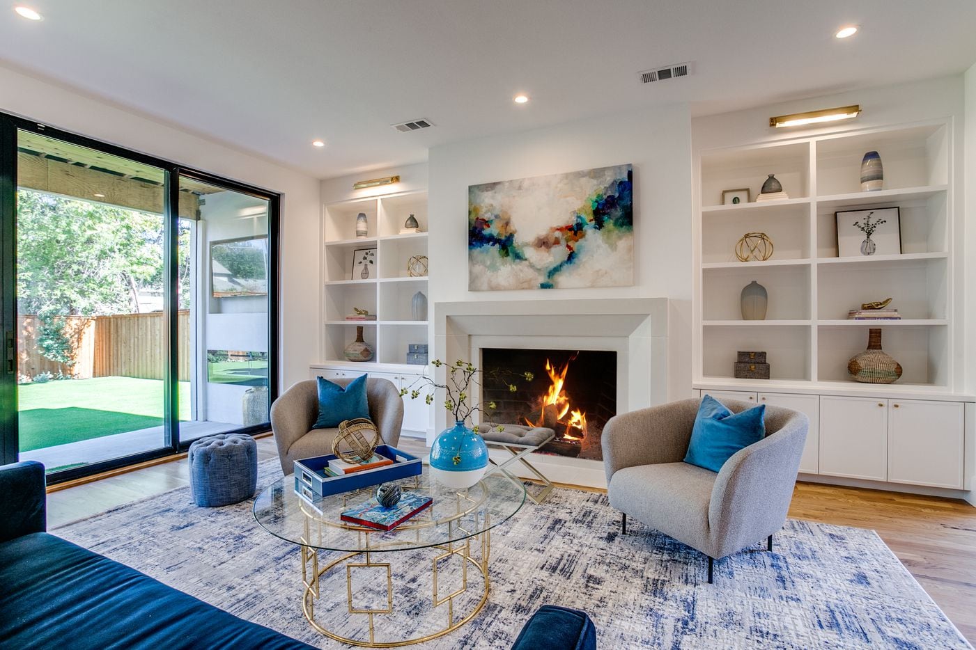 The living area features a cozy fireplace, built-in bookshelves and ample seating.