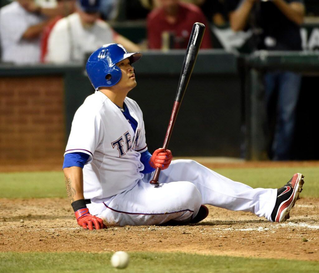 Texas Rangers designated hitter Shin-Soo Choo (17) watches after a wild pitch almost hit him...