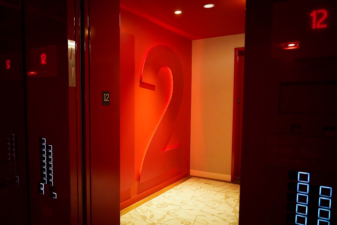 A view from the red-hued elevators out to the red-hued floor numbers at the new the Virgin...