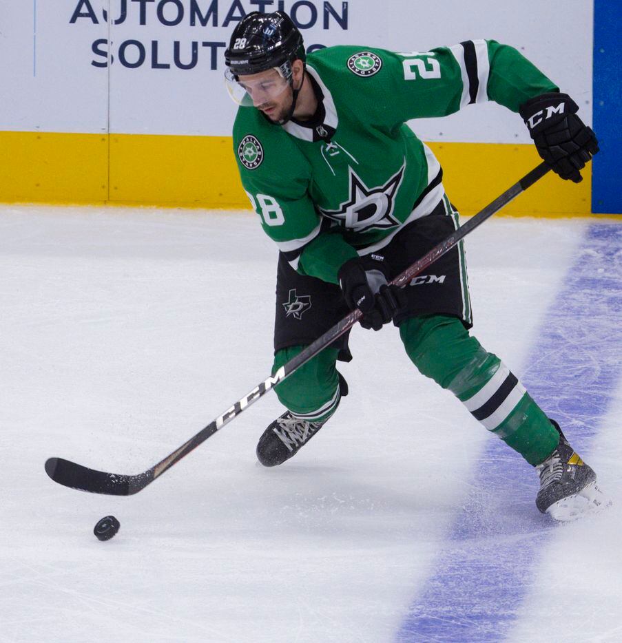 Dallas Stars defenseman Stephen Johns (28) guides the puck during the third period of a Dallas Stars preseason game against St. Louis Blues on Tuesday, Oct. 5, 2021, at American Airlines Center in Dallas. (Juan Figueroa/The Dallas Morning News)