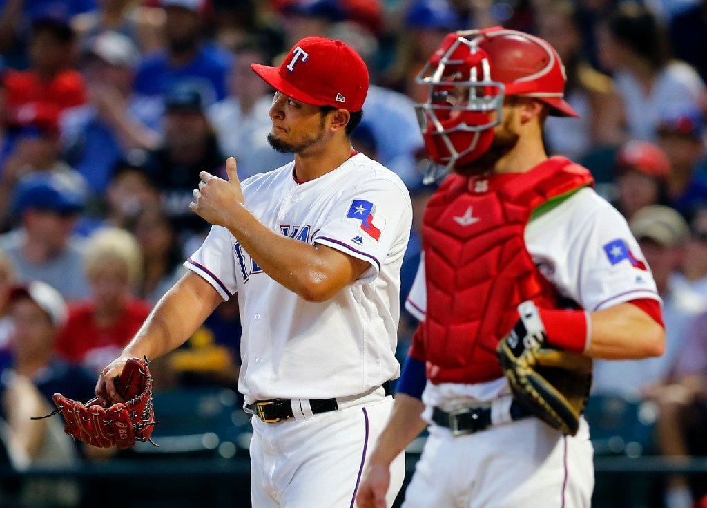 Texas Rangers starting pitcher Yu Darvish (left) reacts after Miami Marlins Marcell Ozuna's...
