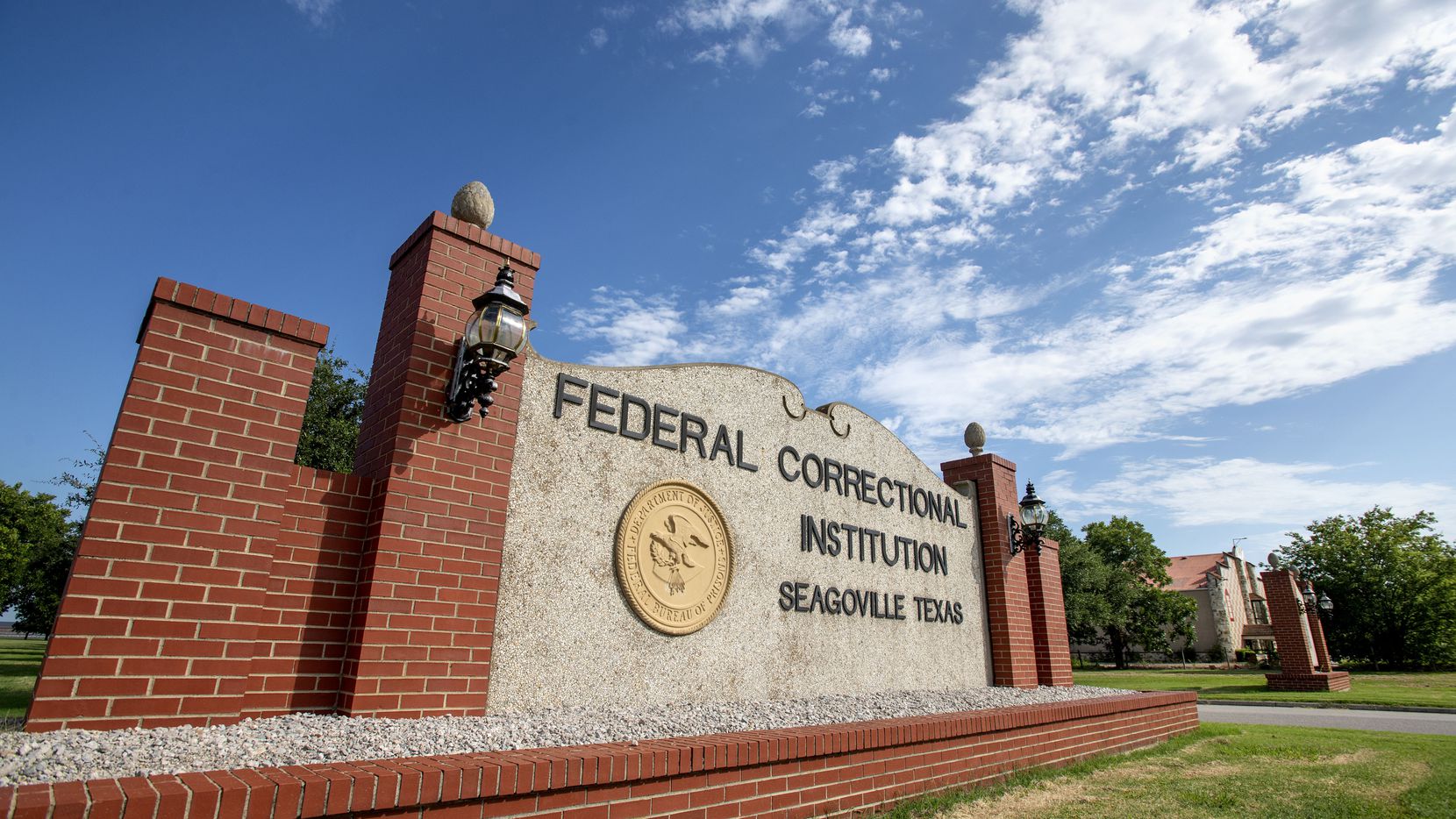 A sign marks the entrance to the Federal Correctional Institution in Seagoville, where there...