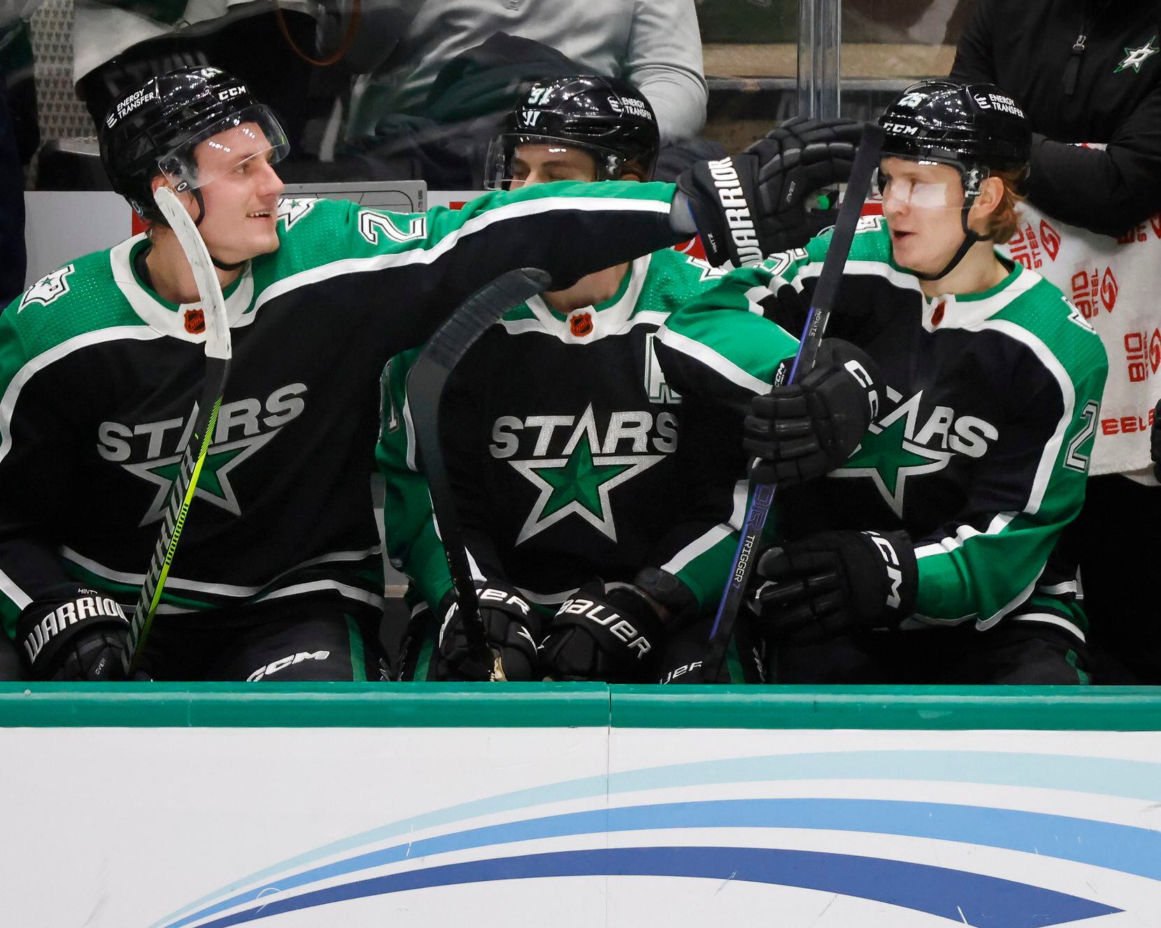Dallas Stars center Roope Hintz (left) reaches over and congratulates left wing Joel...