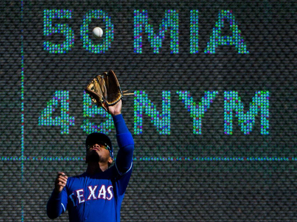 FILE - Rangers left fielder Willie Calhoun (5) catches a fly ball during the ninth inning of...