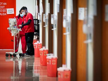 Staff work in the quiet hallways of the COVID-19 unit on Jan. 5, 2022.