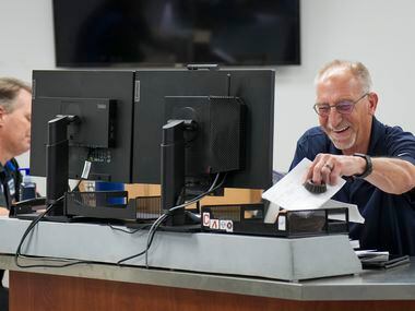 Chuck Korbish laughs with a colleague in the parts department at Huffines Chrysler Jeep...