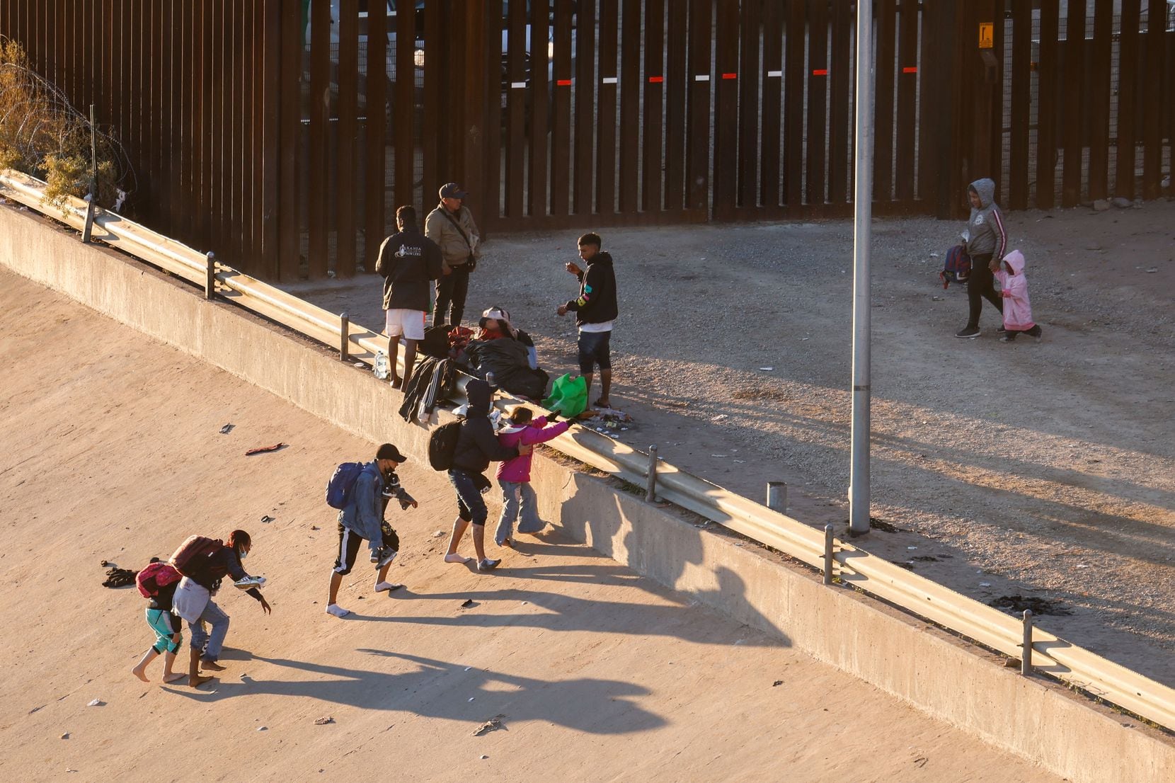 Migrants cross the Rio Grande into El Paso from Ciudad Juarez, Mexico, on Dec. 21, 2022.